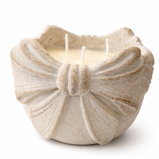Decorative candle in a shell-shaped holder on a white background