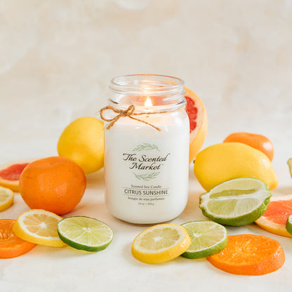Jar of candle with citrus fruits on a light background