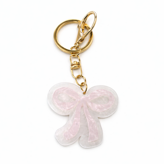 Keychain with a pink bow design on a white background
