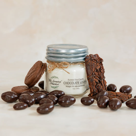 Jar of chocolate truffles with chocolate pieces on a light background
