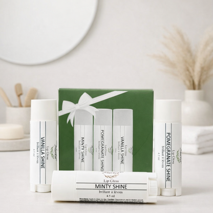 Set of lip balm containers with a green  box on a white surface