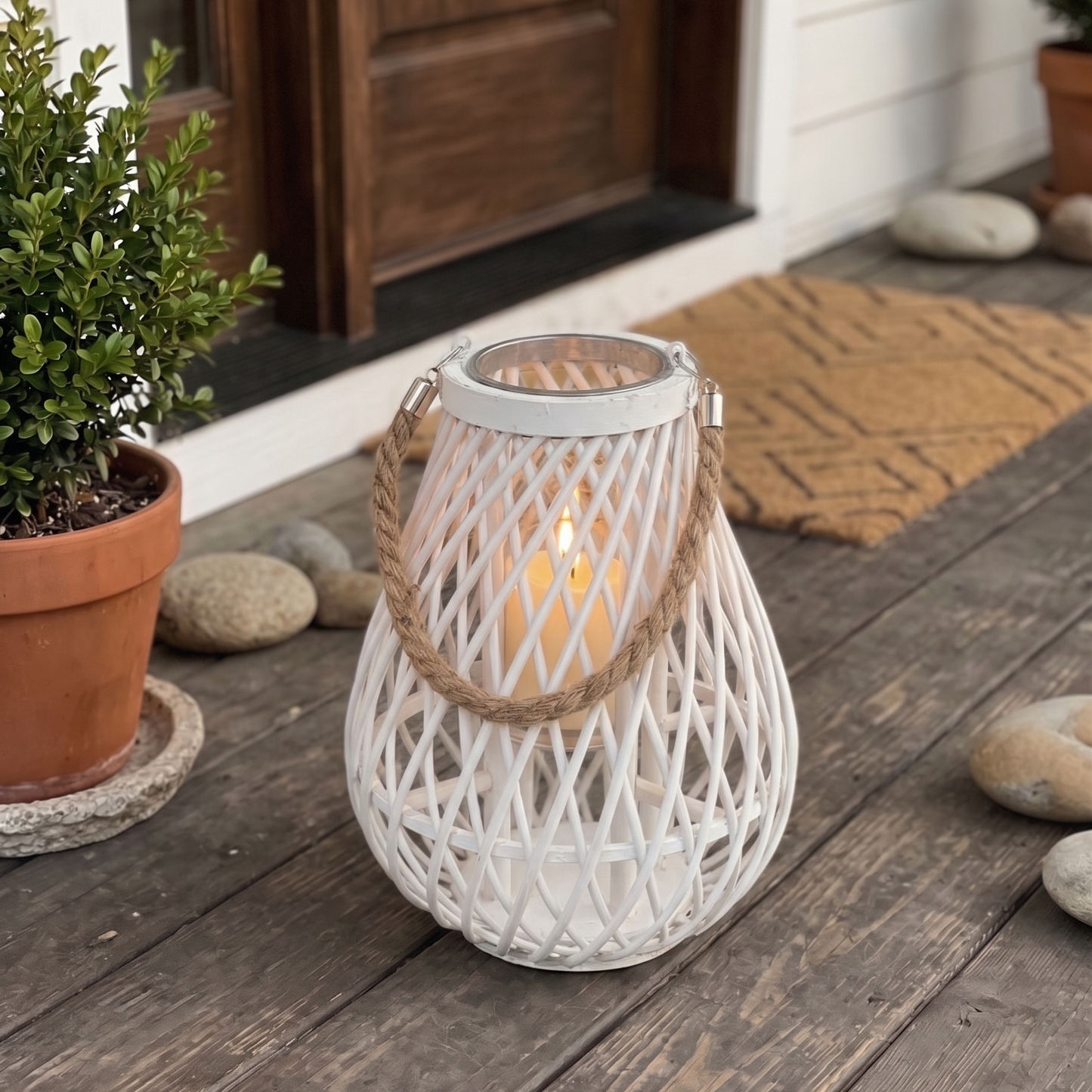 White woven lantern with a candle on a wooden porch