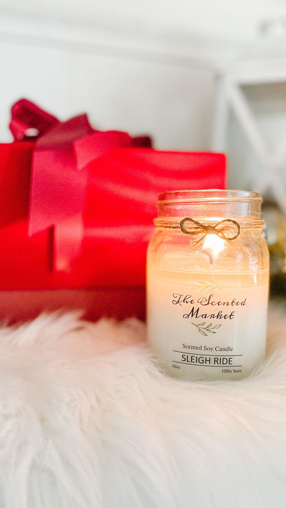 Winter Sleigh Ride 16 ounce scented soy wax candle in a winter setting
